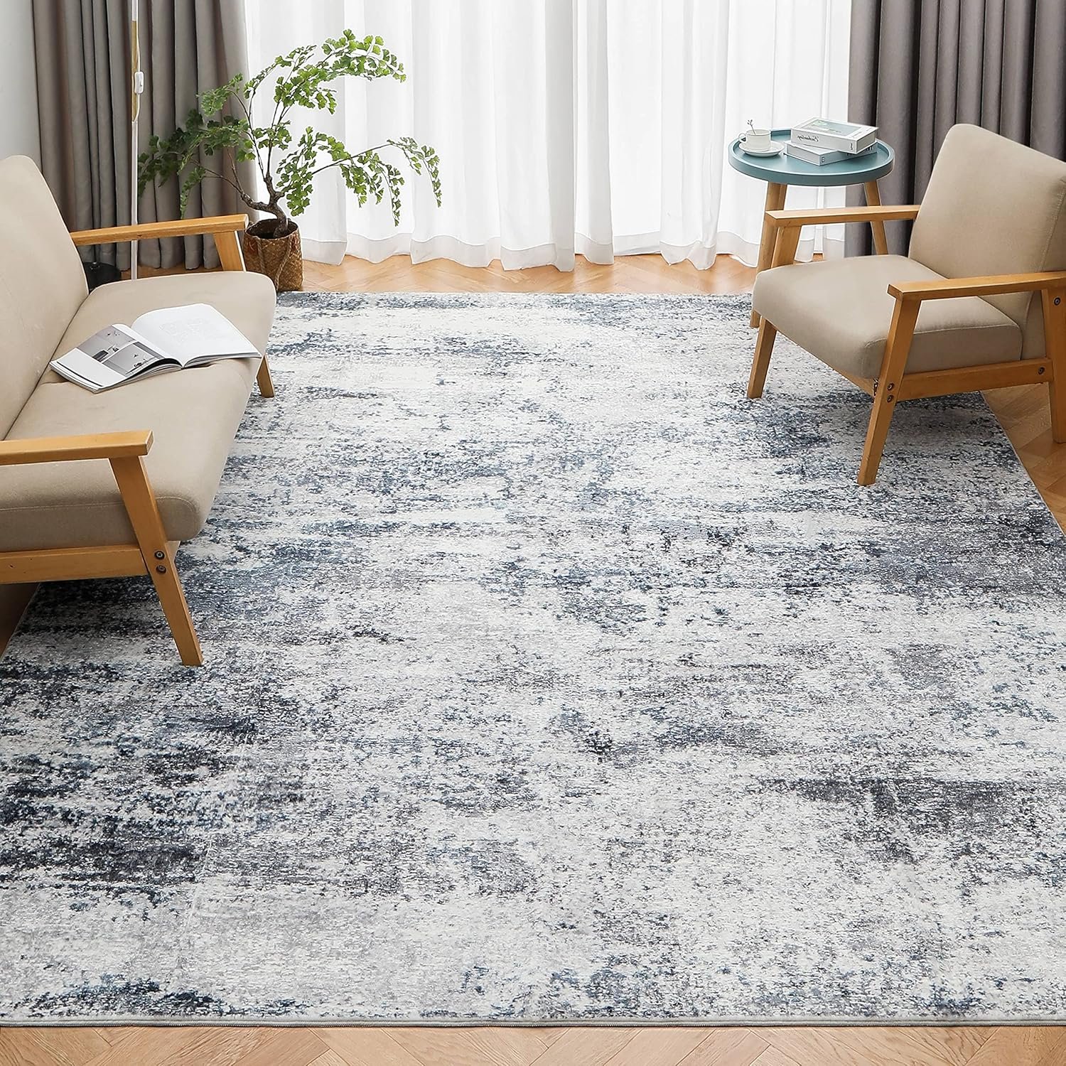 Blue and grey modern abstract living room rug styled in a cozy living room.